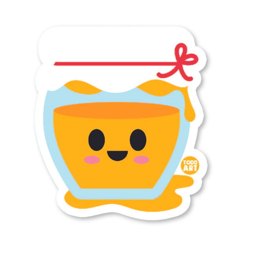 A die-cut vinyl sticker of a smiling honey pot with a red ribbon, designed for use on various surfaces like laptops and water bottles.