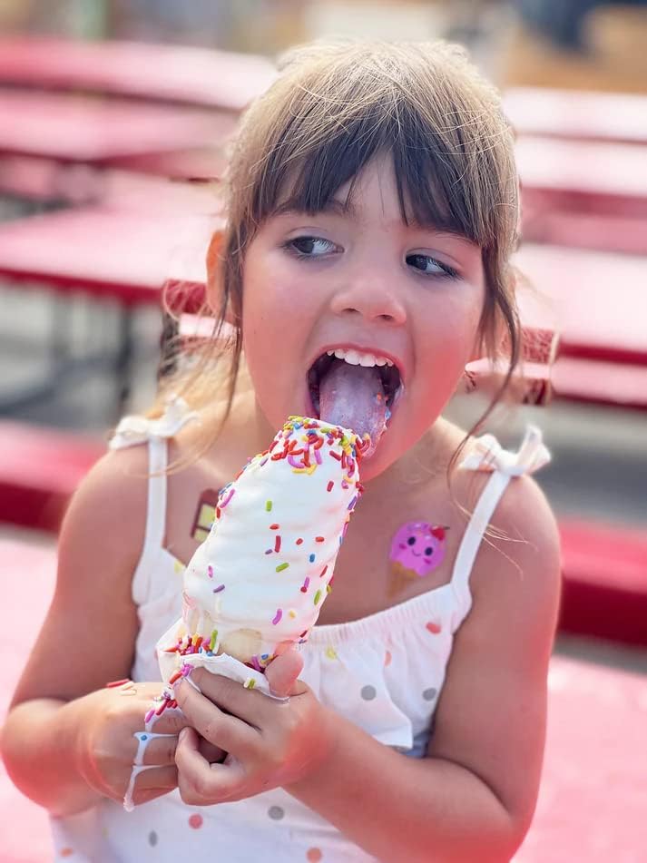 Child enjoying a treat while wearing Boo Boo Buddies fun and colorful kids bandages on her arm and shoulder.
