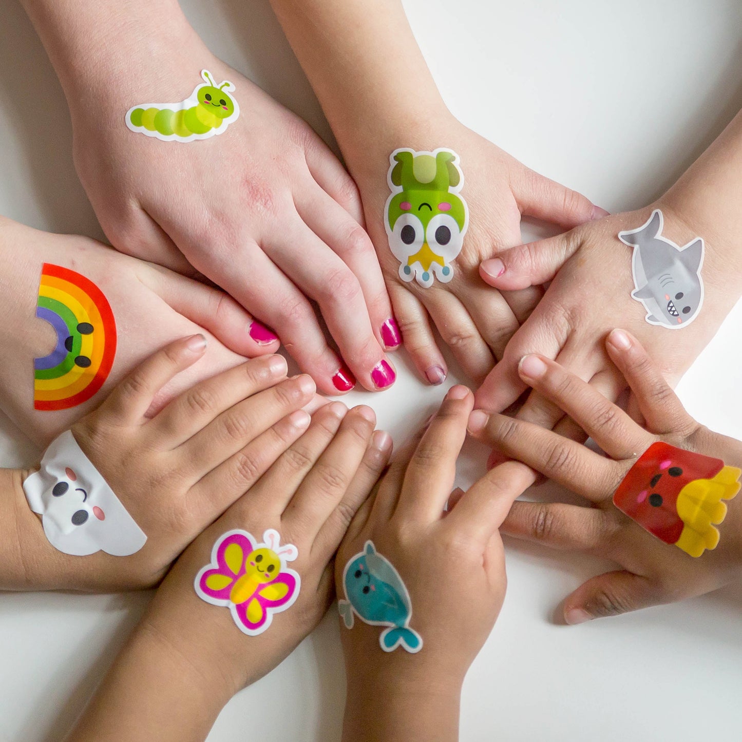 Children showing Boo Boo Buddies colorful kids bandages in a lifestyle setting.
